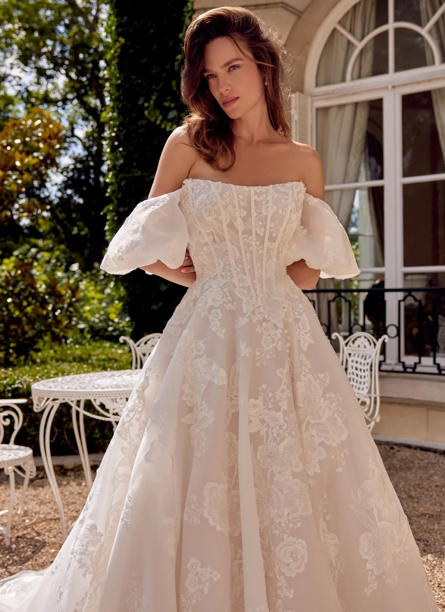 Model wearing a white dress near the piano